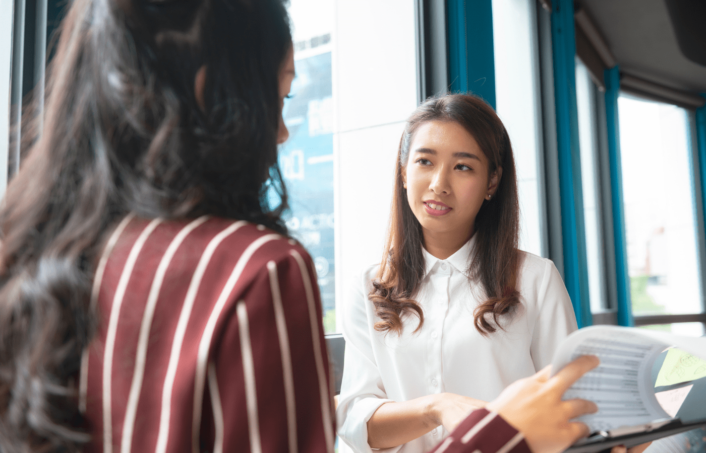 Two business women discussing coaching programmes